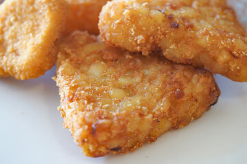 Delicious golden fried chicken pieces on a plate