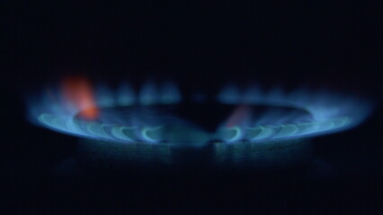 A CloseUp View of a Blue Flame Gas Burner Set Against a Dark Background at Night