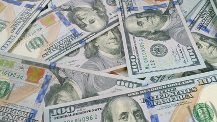 Numerous Scattered US Dollar Bills Laid Out on a Surface for Observation and Analysis