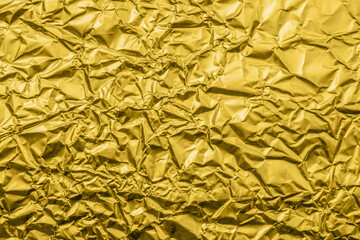 Luxury shiny metallic golden foil crumpled texture background