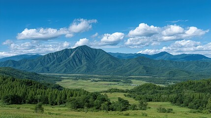 Obraz premium Lush mountain valley under a vibrant blue sky.