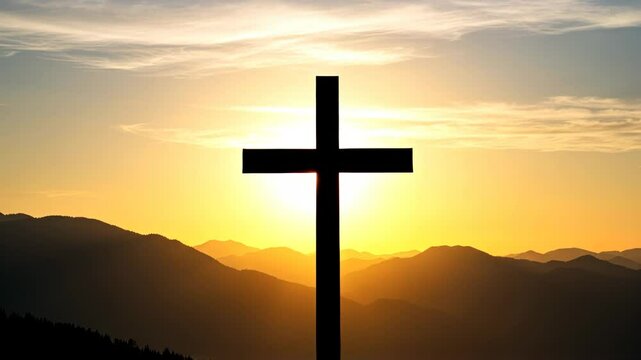 The Christian cross ontop of a hill with mountaintop landscape background during a beautiful sunrise