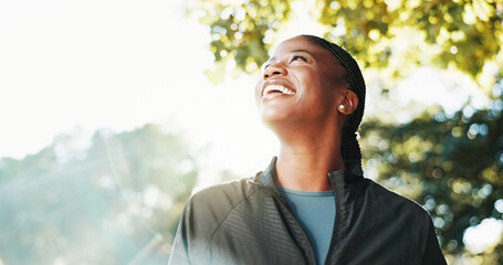 Thinking, hiking and happy black woman with nature, smile and wellness for hobby, explore and travel. Space, hiker and person with woods, vacation activity and sightseeing for environment and break