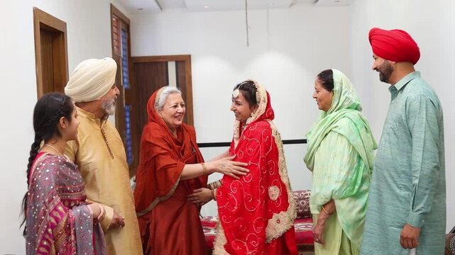Punjabi sikh family celebrating,meeting and greeting on lohri or baisakhi festival at home, People of punjab, Culture of india. Mother and daughter hug each other, Togetherness and bonding