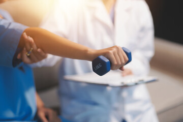 Unrecognizable uses blue hand weight during physical therapy session