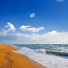 emerald sea bay with sandy  beach  under blue cloudy sky, summer sea vacation scene