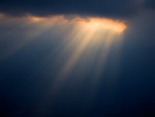 Fototapeta premium Sunbeams breaking through dark clouds, creating a dramatic and awe-inspiring scene