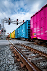 Fototapeta premium colorful train cars speeding through an intersection