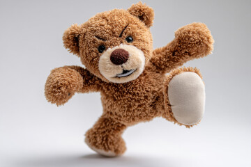Obraz premium brown stuffed bear with behavior kicking on white Background