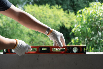 Measuring precision leveling a surface in a lush garden instructional content outdoor setting...
