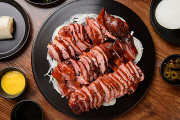Smoked duck slices sprinkled with black sesame seeds
