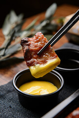 Smoked duck dipped in mustard sauce

