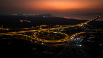 India's longest sea bridge: Trans-Harbour Sea Link. Atal Setu sea bridge in Mumbai, Maharashtra, India. Time-lapse of a city at night with bright skyscrapers and a dense network of glowing buildings.