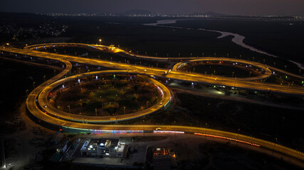 India's longest sea bridge: Trans-Harbour Sea Link. Atal Setu sea bridge in Mumbai, Maharashtra, India. Time-lapse of a city at night with bright skyscrapers and a dense network of glowing buildings.