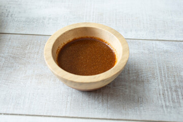 A view of an Asian marinade sauce in a wood bowl.