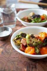 A view of some bowls of marinated Brussels sprouts.