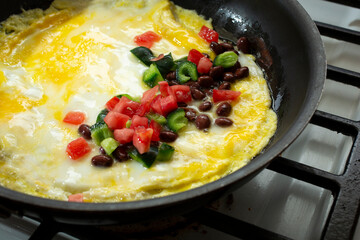 A view of a Southwestern omelet, in a non-stick skillet.