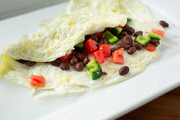 A view of an egg white Southwestern omelet, on a plate.