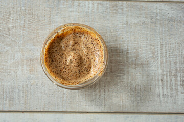 A top down view of a condiment cup of chipotle dip.