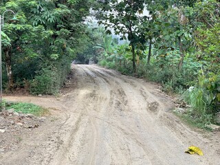 The condition damaged roads during the rainy season which are used by many vehicles such as cars and truck. Muddy and slippery dirt roads. Danger road, causes of accidents