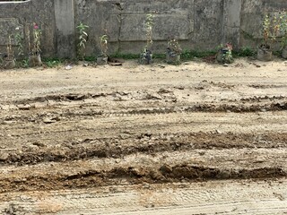 Close up the damaged roads during the rainy season. Muddy and slippery dirt roads because many...