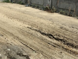 Close up the damaged roads during the rainy season. Muddy and slippery dirt roads because many...