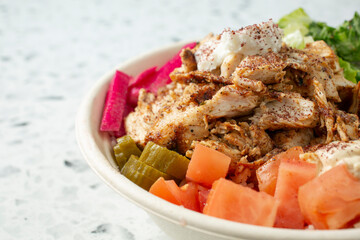 A closeup view of a chicken shawarma bowl.
