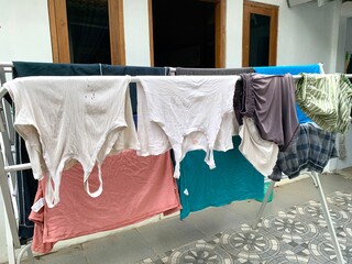 Close up different clothes drying on laundry line on a summer day