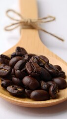 A close-up shot of coffee beans, cradled in a wooden spoon, presenting a rustic touch. with detail textures.