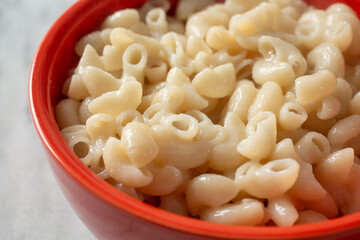 A closeup view of a bowl of cooked gluten-free elbow macaroni.