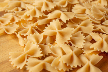 A closeup view of a pile of dry gluten-free farfalle.
