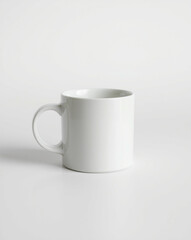 Obraz premium Simple white ceramic mug on white backdrop.