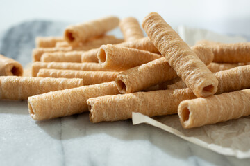A closeup view of a pile of coconut rolls.