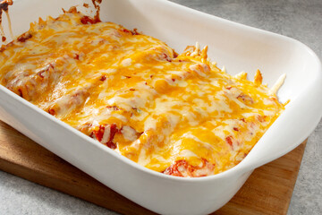 A closeup view of a casserole dish of enchiladas.