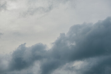 Overcast sky with thick gray clouds during late afternoon, creating a moody and dramatic atmosphere. Perfect for weather themes, storm backgrounds, or environmental and nature concepts.