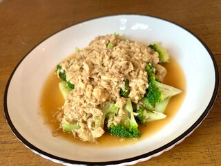 Close up Stir Fried Broccoli or Ca Broccoli on the plate with scrambled egg on the top. Healthy and delicious food for diet. High protein and fiber for vegan