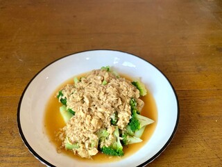 Close up Stir Fried Broccoli or Ca Broccoli on the plate with scrambled egg on the top. Healthy and delicious food for diet. High protein and fiber for vegan. Copy space for background