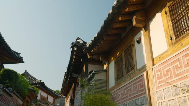 Bukchon Hanok Village Traditional Rooftops, Jongno-gu, Seoul, Korean Architecture at sunset pan shot