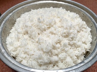 Close up of white rice on the pan in kitchen. Rice after being cooked using a pan. Staple food of indonesian people