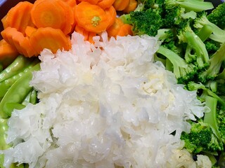 Close up some vegetables like snow mushroom, carrot, broccoli, cauliflower, and capri