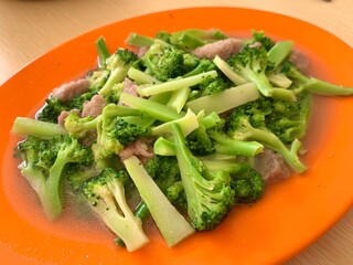 Close up of Ca Broccoli with meat on the plate. Healthy food for diet. Delicious homemade food