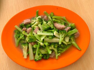 Close up of Ca Broccoli with meat on the plate. Healthy food for diet. Delicious homemade food