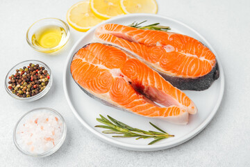 Salmon fillets prepared with seasonings and fresh ingredients for cooking