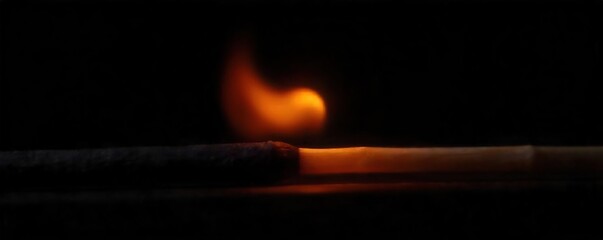 Close-up shot of a newly lit match, the flame vibrant orange and yellow against a stark black background, emphasizing the raw energy and primal nature of freshly ignited fire ,  raw,  detail