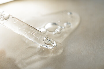 An eyedropper with a drop of oil or a cosmetic product for face and body. Natural organic cosmetics. The concept of body care.