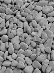 Plakat Top view of natural pebbles in black and white