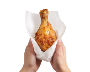 Person holding a fried chicken leg in a white paper wrapper