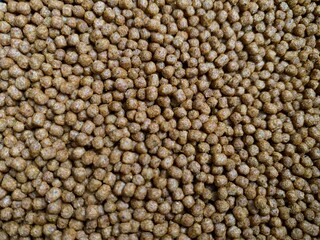Close up of fish pellets. Food for fish in pond