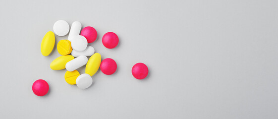 Medical pills, tablet, assorted drugs on grey background, top view