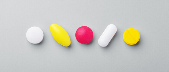 Assorted medical pills, tablet, drugs on grey background